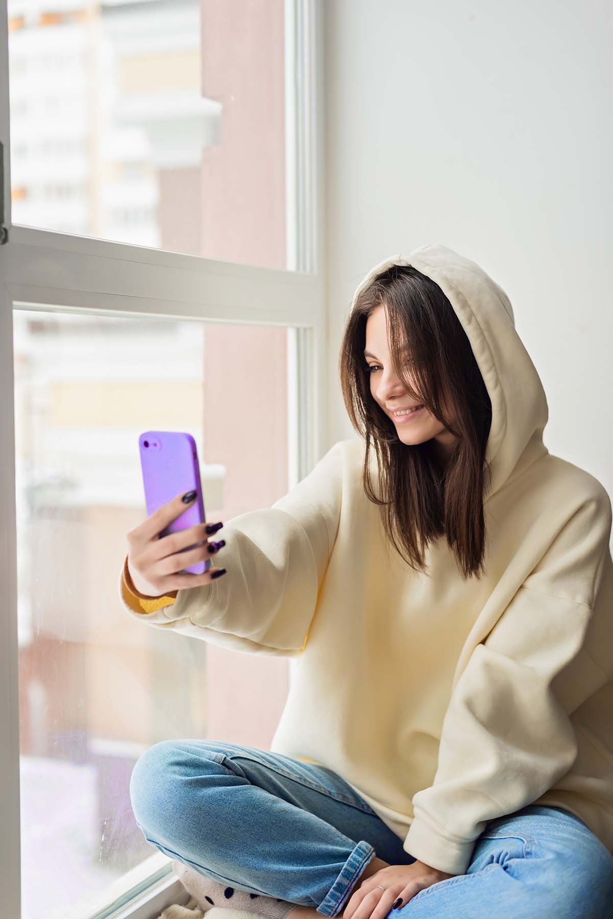 happy-female-blogger-taking-selfie-portrait-on-sma-6595WQN